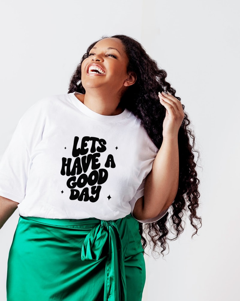 Front of a model wearing a size L Let's Have A Good Day Short Sleeve Graphic Tee in White by Simply Sage Market. | dia_product_style_image_id:283217